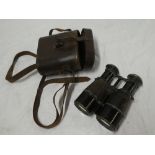 A pair of First War painted metal binoculars marked "National Defense Binocular" in leather