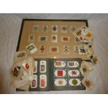 A framed display of silk cigarette cards - Military Badges;