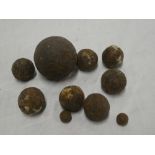 A selection of old small iron cannon balls and shot (originally from Mylor harbour)