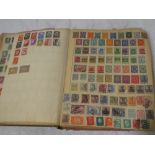An old album containing a collection of Commonwealth and World stamps