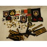 Various military and naval cloth badges, military buttons, pair of "UNRRA" titles,