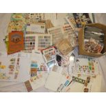 A box containing a large selection of mixed World stamps, first day covers, stamps on album leaves,
