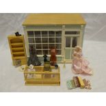 A doll's 1/12th shop setting fitted with shop counter, displays, clothing and mannequin,