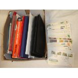 A box containing various empty stamp albums, catalogues, stock leaves,