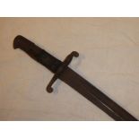 An 1856 pattern Enfield sword bayonet with single edged blade and leather grips (one grip af)