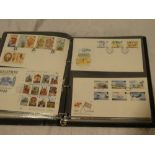 A folder album containing a collection of over 110 Guernsey first day covers 1972 - 1995