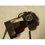 A Certo Dollina 11 folding camera with lens hood and leather carrying case