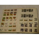 A stock book containing a good collection of GB stamps, mainly gutter pairs,