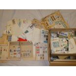 A box containing a large selection of mint and used loose stamps, first day covers, postal covers,