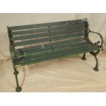 A Victorian cast iron garden bench with scroll ends and wooden slats (af),