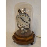 A good quality electric mantel clock with chromium plated mounts within glass display dome