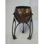 An Art Nouveau WMF Jugendstil copper and brass circular planter on pierced stylized tapered legs,