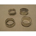 Four various silver oval/circular napkin rings