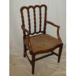 A 19th Century carved mahogany carver armchair with decorated rail back and upholstered seat on