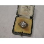 A 19th Century gold dress ring set central diamond surrounded by ten smaller diamonds