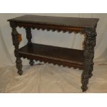 A 19th Century carved oak rectangular two tier buffet on bulbous turned supports with casters,