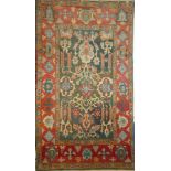 A good quality Eastern rectangular wool rug with floral and geometric decoration on green and red