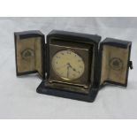 A small brass square travelling clock By Carrington of London in blue Morocco leather maker case