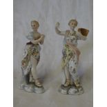 A pair of 19th Century porcelain figures of classical females wearing floral robes,