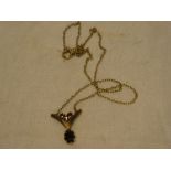 A 9ct gold pendant necklace with V-shaped pendant set garnets