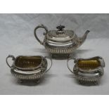 A late Victorian silver three-piece tea set comprising a rectangular teapot with gadrooned