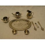 A miniature silvered oval tray with engraved decoration together with matching miniature tea set,