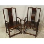 A pair of Chinese rosewood carver armchairs with decorated splat backs and polished seats on turned