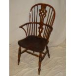 A 19th Century yew and elm Windsor armchair with shaped seat on turned tapered legs