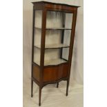 A late Victorian inlaid mahogany bow fronted display cabinet with fabric lined shelves enclosed by