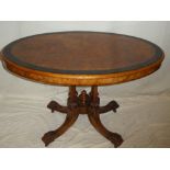 A Victorian burr walnut and coromandal oval centre table on four slender supports with scroll feet,