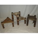 Three various old African carved and painted wood stools with natural skin seats