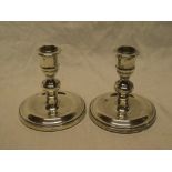 A pair of good quality silver candlesticks with tapered stems and circular bases, 4¼" high,