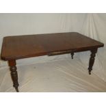 A Victorian walnut rectangular extending dining table with one additional centre leaf on turned