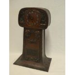 An unusual Art Deco copper cased mantel clock decorated in relief with stylized flowers,