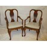 A pair of walnut Chinese-style carver armchairs with decorated vase splat backs and upholstered