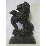 A Victorian cast iron doorstop in the form of a lion rampant with shield,