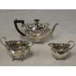An Edward VII silver oval three piece tea set comprising teapot with hinged lid,