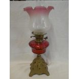 A Victorian oil lamp with cast iron base,