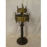 An unusual brass and iron ecclesiastical-style candle lamp standard with ten sconces,