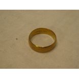 A large 9ct gold wedding band