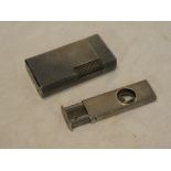 A small silver rectangular cigar cutter with engine turned decoration,