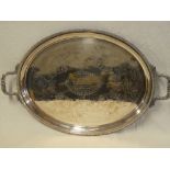 A large Victorian electroplated oval two-handled tea tray with engraved decoration and scroll