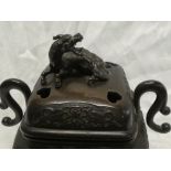 A 19th Century Japanese bronze square two handled koro and cover with raised floral decoration and