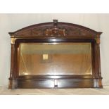 A Victorian bevelled rectangular over mantel mirror in carved mahogany surround with column