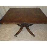 A mid 19th Century mahogany rectangular turnover top breakfast table on turned column with carved