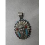 An unusual sterling silver pendant in the form of a Red Indian head-dress set mother-of-pearl and