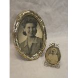 A George V silver oval photo frame with raised decoration,