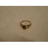 A 9ct gold dress ring set a heart-shaped garnet