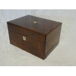 A Victorian figured walnut toiletry box with fitted interior having numerous compartments and glass