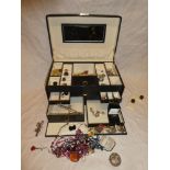 A jewellery box containing a quantity of various costume jewellery including silver dress rings,